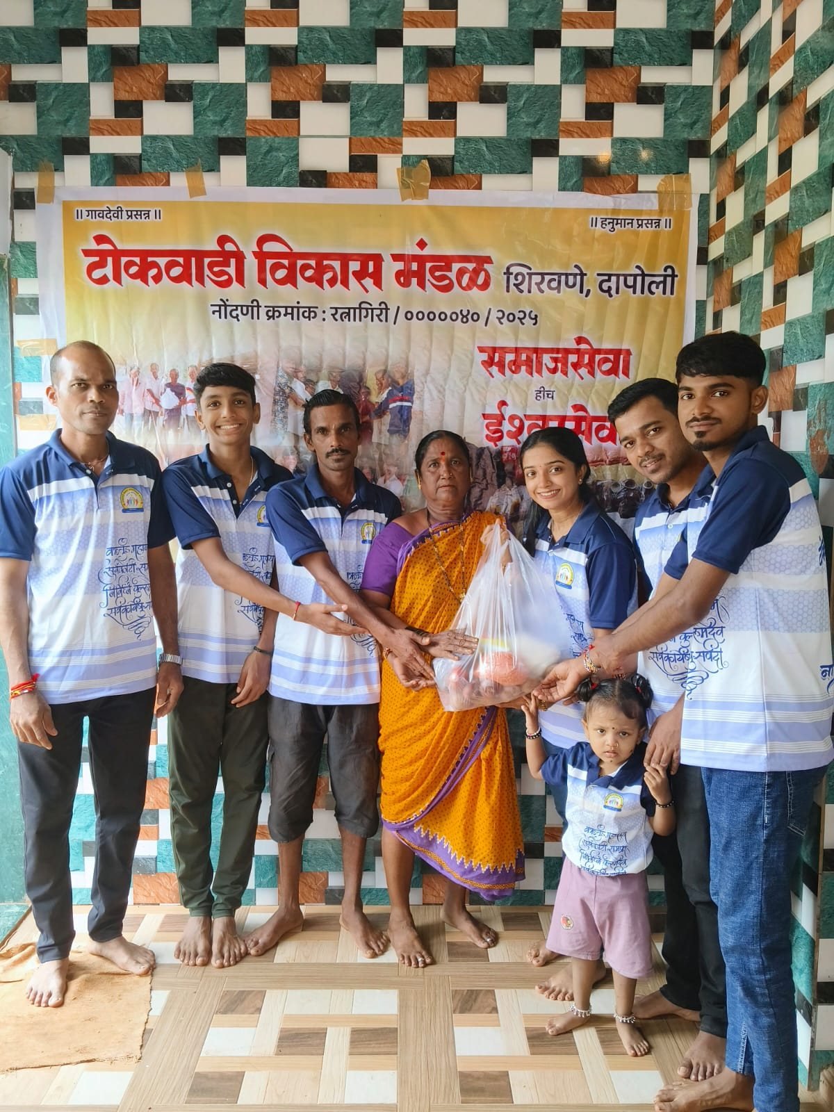 Team members with a family during community food grain distribution